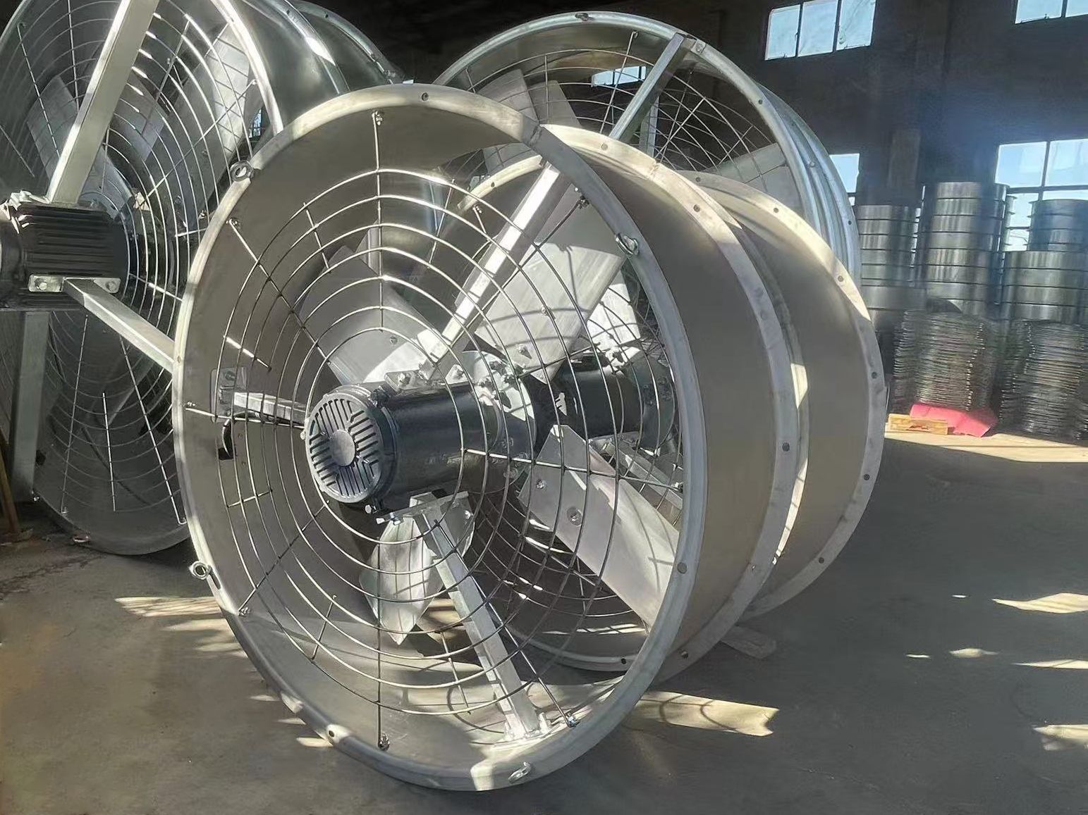 Large industrial cooling tower fan assembly with protective casing